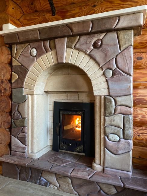 Photo by Anna Chip on Pexels Cozy stone fireplace with a warm glow, creating a rustic and inviting atmosphere indoors.