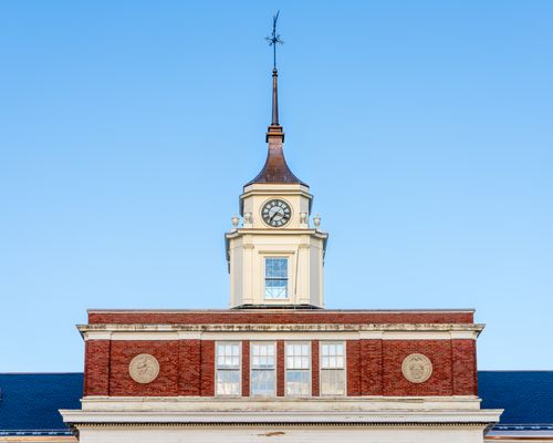 Free Elegant brick clock tower against a clear blue sky in Somerville, MA. Stock Photo
