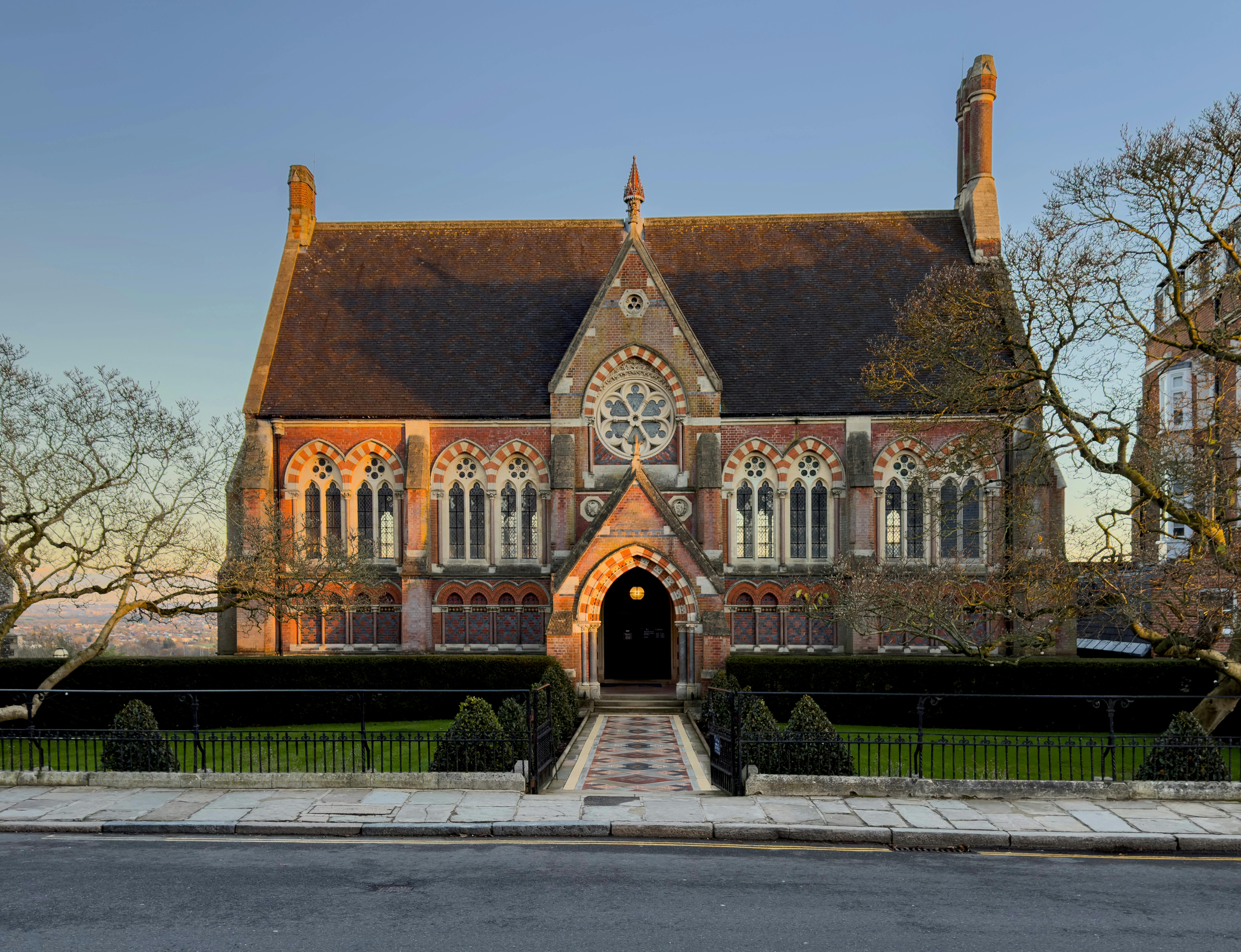 A beautiful view of the historic Harrow School building during sunset, showcasing its Gothic architecture.