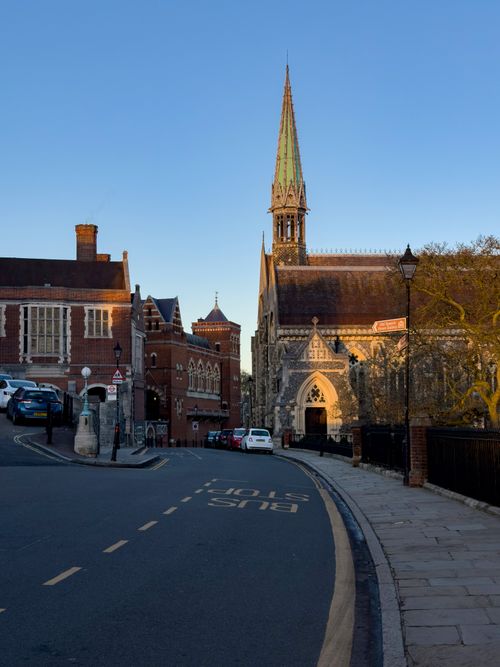 Free Capture of a peaceful street in Harrow on the Hill, featuring historic architecture and warm evening light. Stock Photo