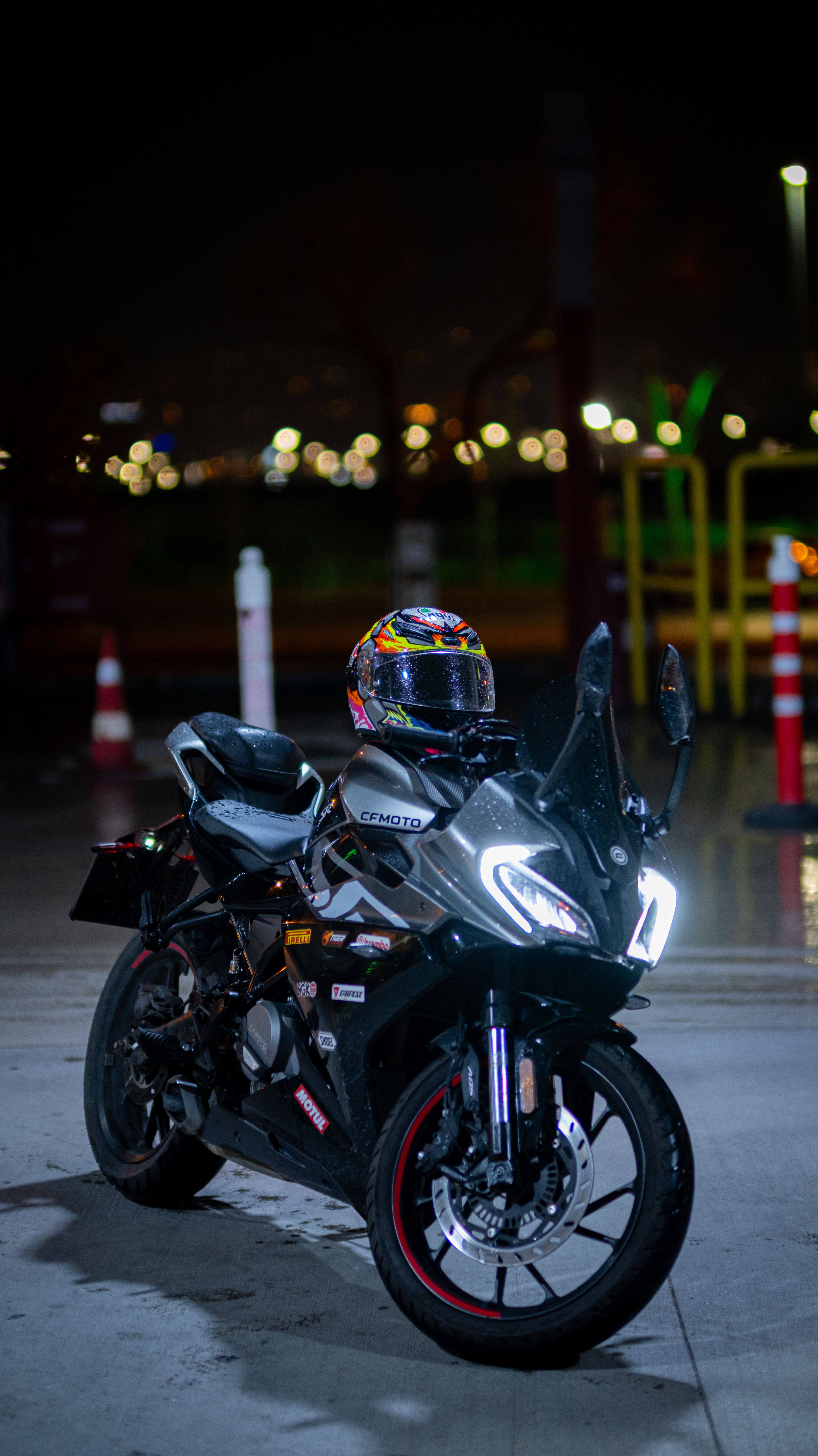 Sleek Motorcycle with Helmet at Night · Free Stock Photo