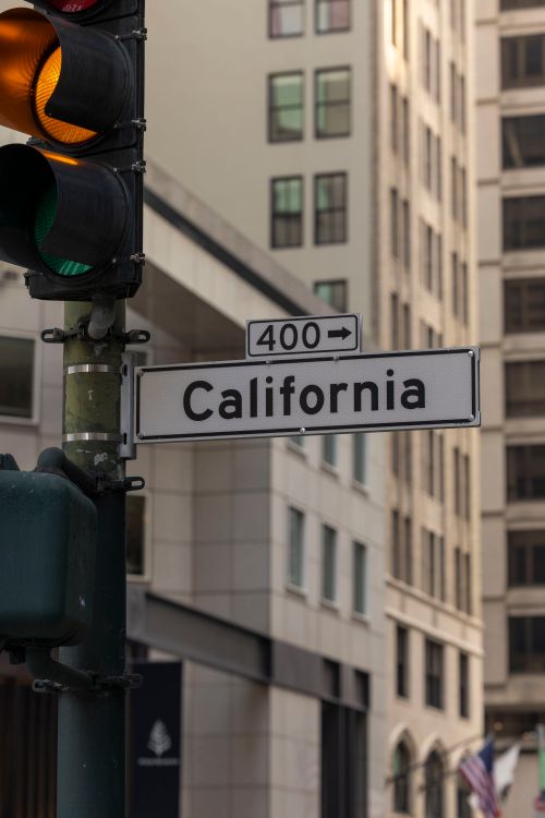 Free Street sign in downtown California next to traffic light, capturing urban city life. Stock Photo