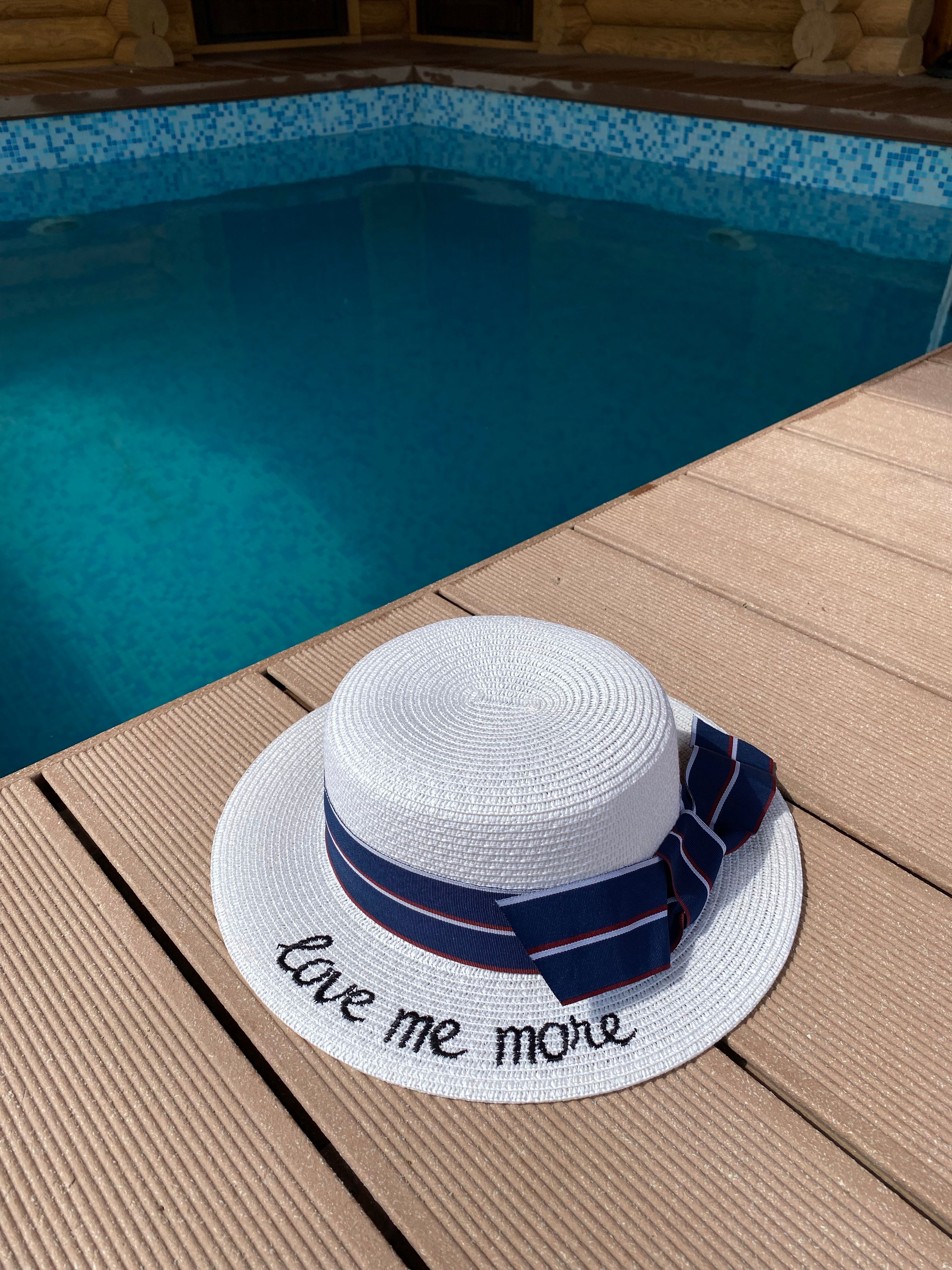 White Straw Hat by Poolside with Love Me More Text · Free Stock Photo