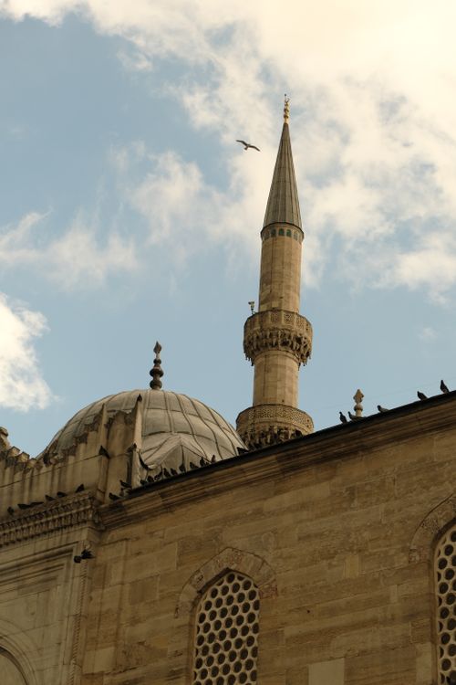 Free A beautiful mosque minaret in Istanbul with birds and a clear blue sky, showcasing Islamic architecture. Stock Photo