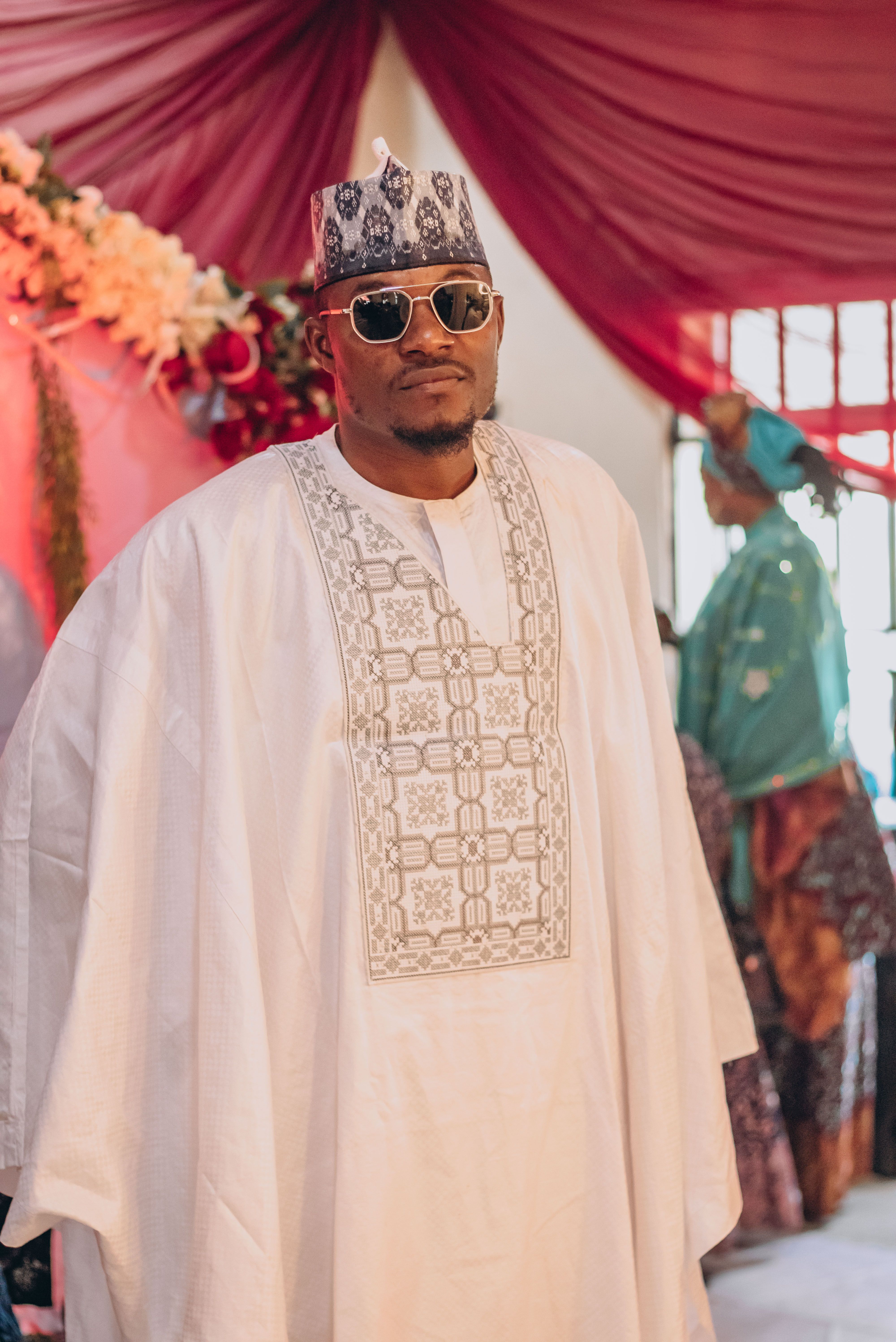 African Man in Traditional White Attire at Event · Free Stock Photo