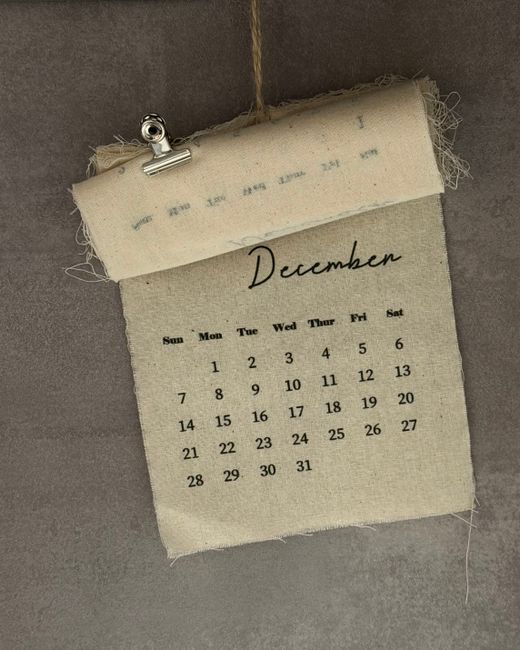 A vintage-style hanging calendar page displaying December dates, ideal for home decor.