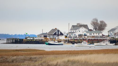 Free Quaint coastal town view with boats and homes in Biddeford, Maine, USA. Stock Photo