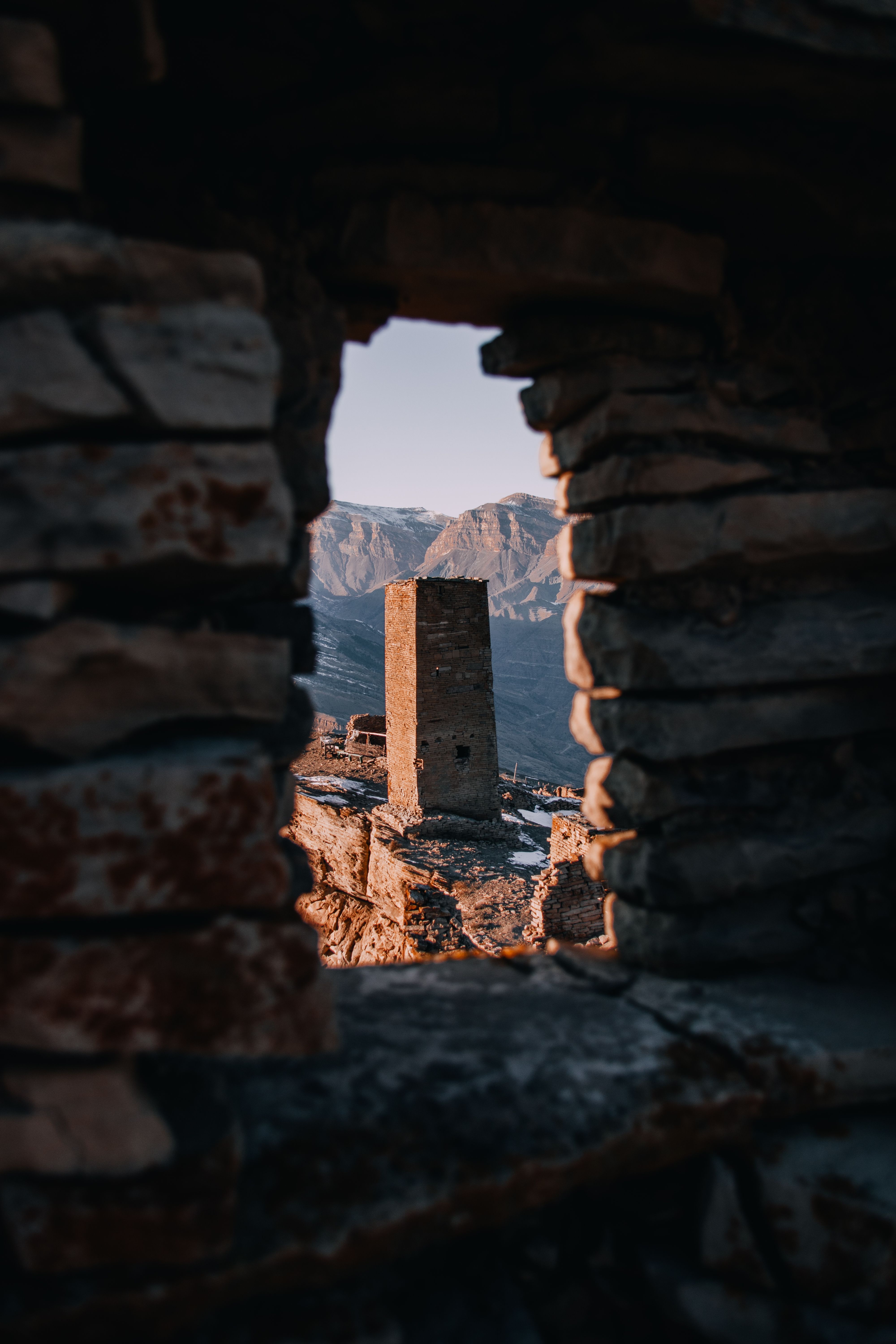 Ancient Stone Tower Framed by Window in Ruins · Free Stock Photo