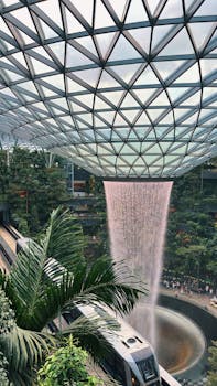 Captivating view of Jewel Changi's indoor waterfall and passing train.