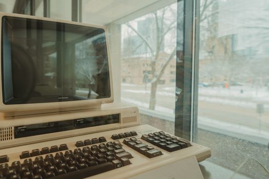 A vintage Epson computer displayed indoors against a snowy window view in Milwaukee during winter.