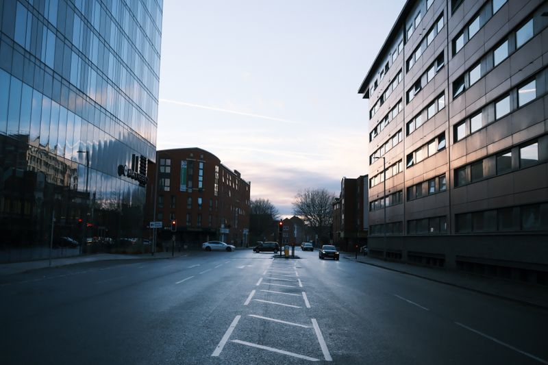 An empty city street at dusk — photo by Max W on Pexels