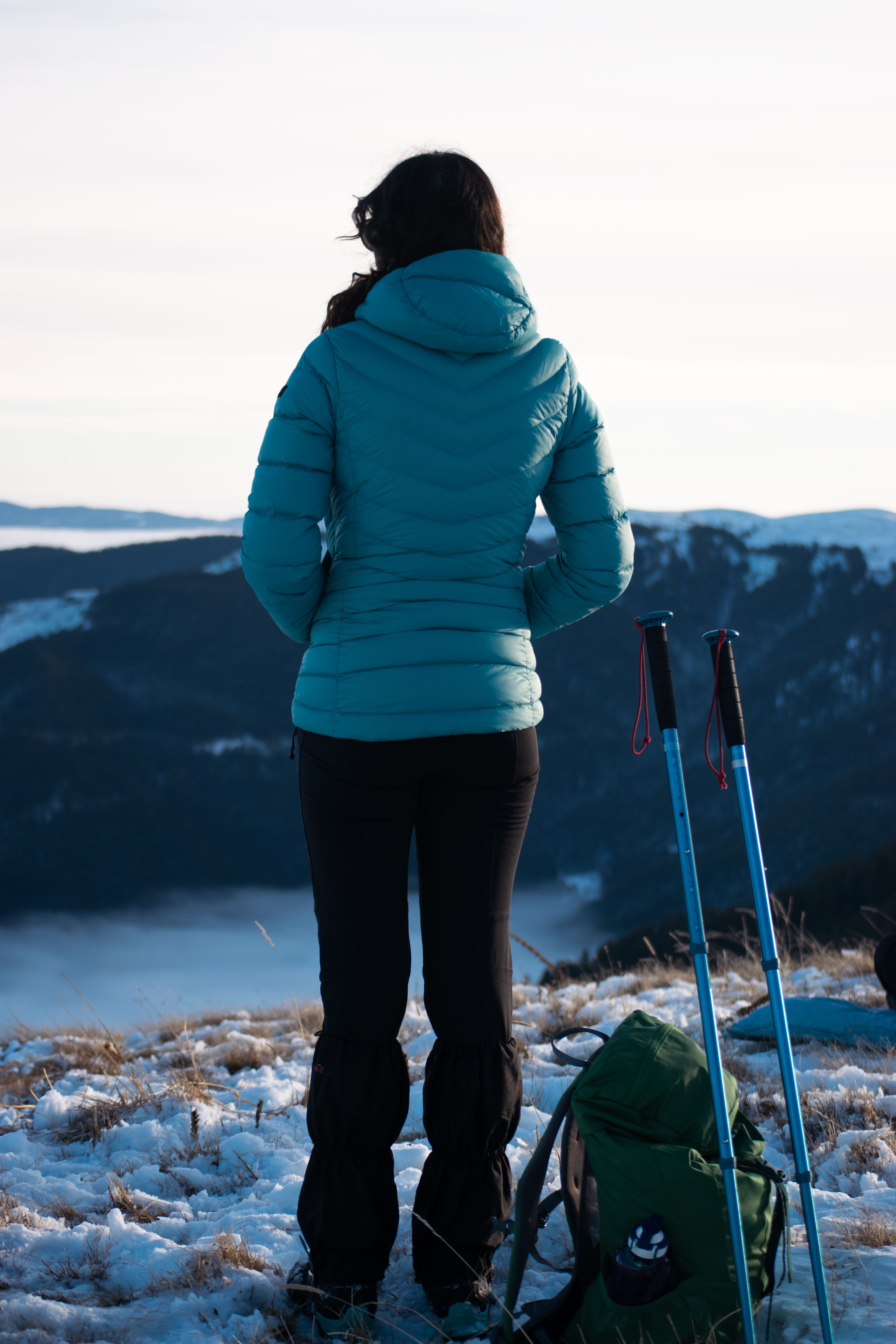 Woman Hiking in Winter Mountains with Backpack