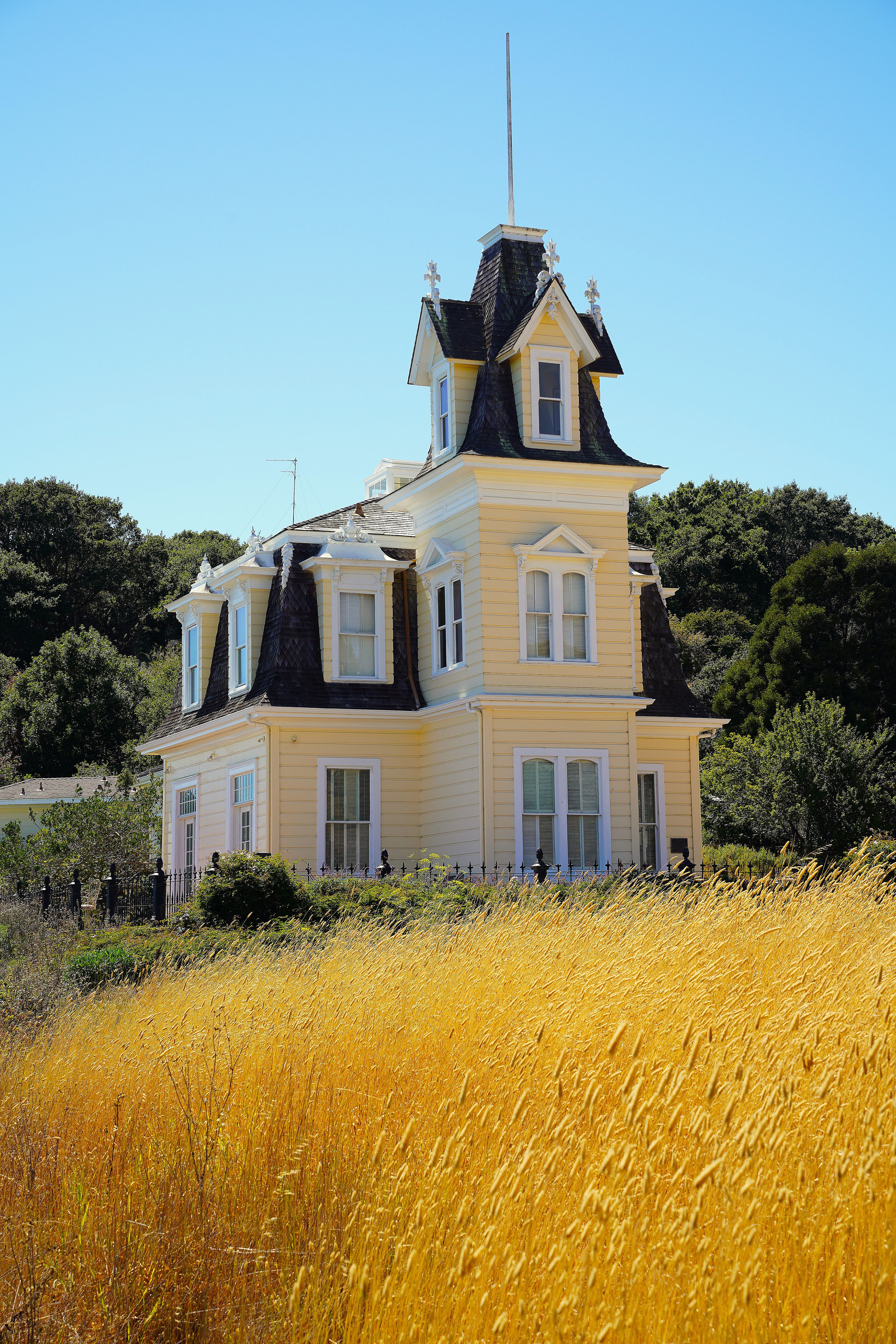 Yellow Victorian farmhouse set against golden fields, representative of the countryside around Garnet Valley, Pennsylvania