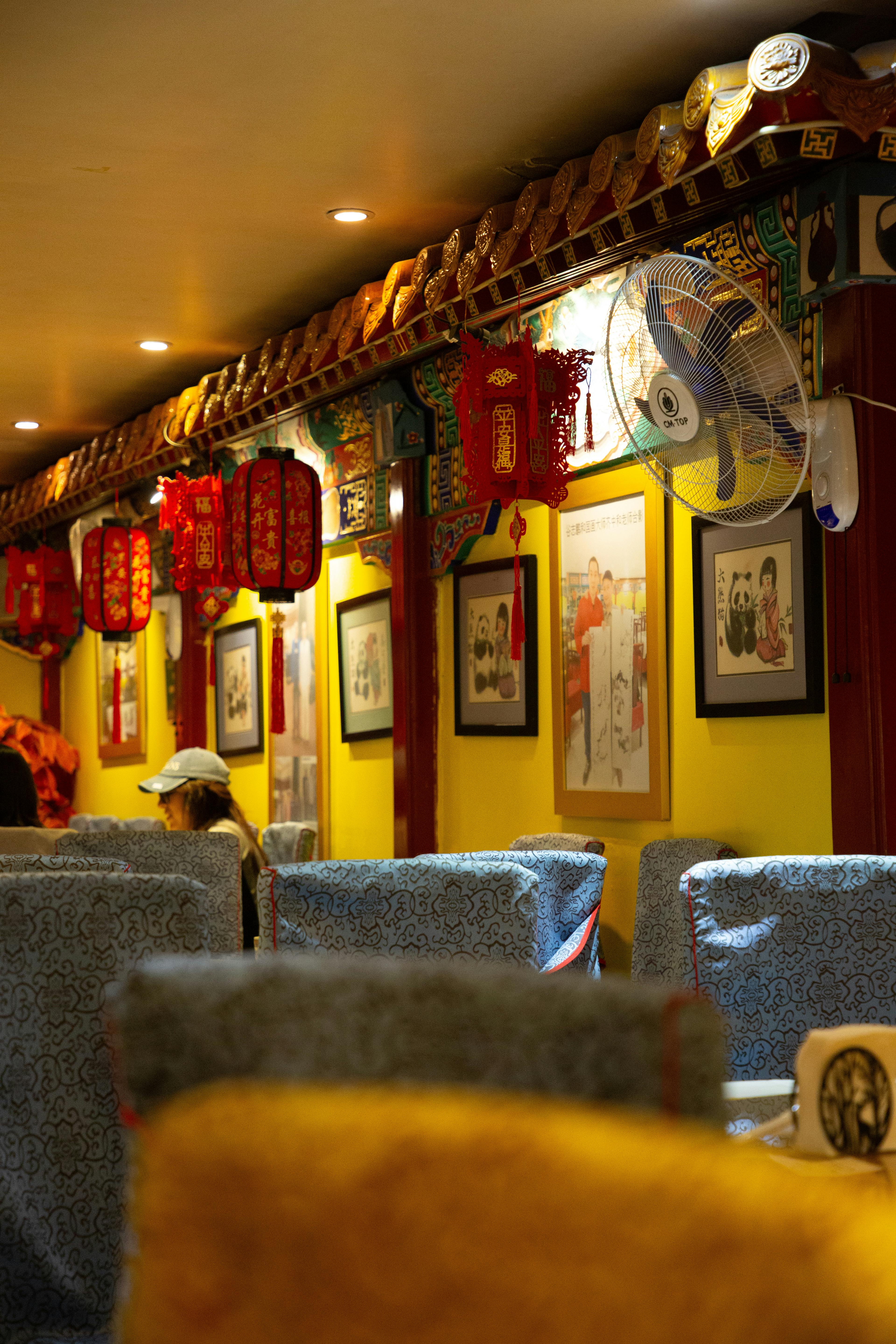 Warm and inviting Chinese restaurant interior with traditional decor and red lanterns.