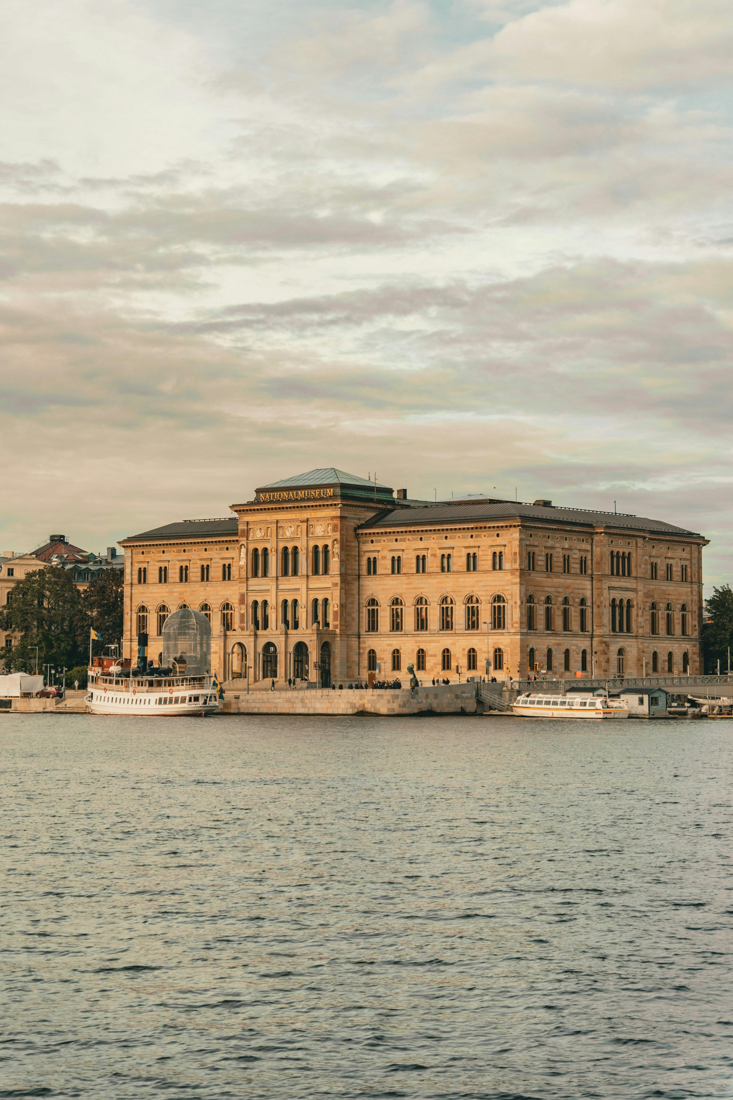 Scenic view of the National Museum in Stockholm with boats on the waterfront.