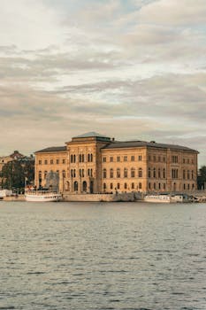 Scenic view of the National Museum in Stockholm with boats on the waterfront.