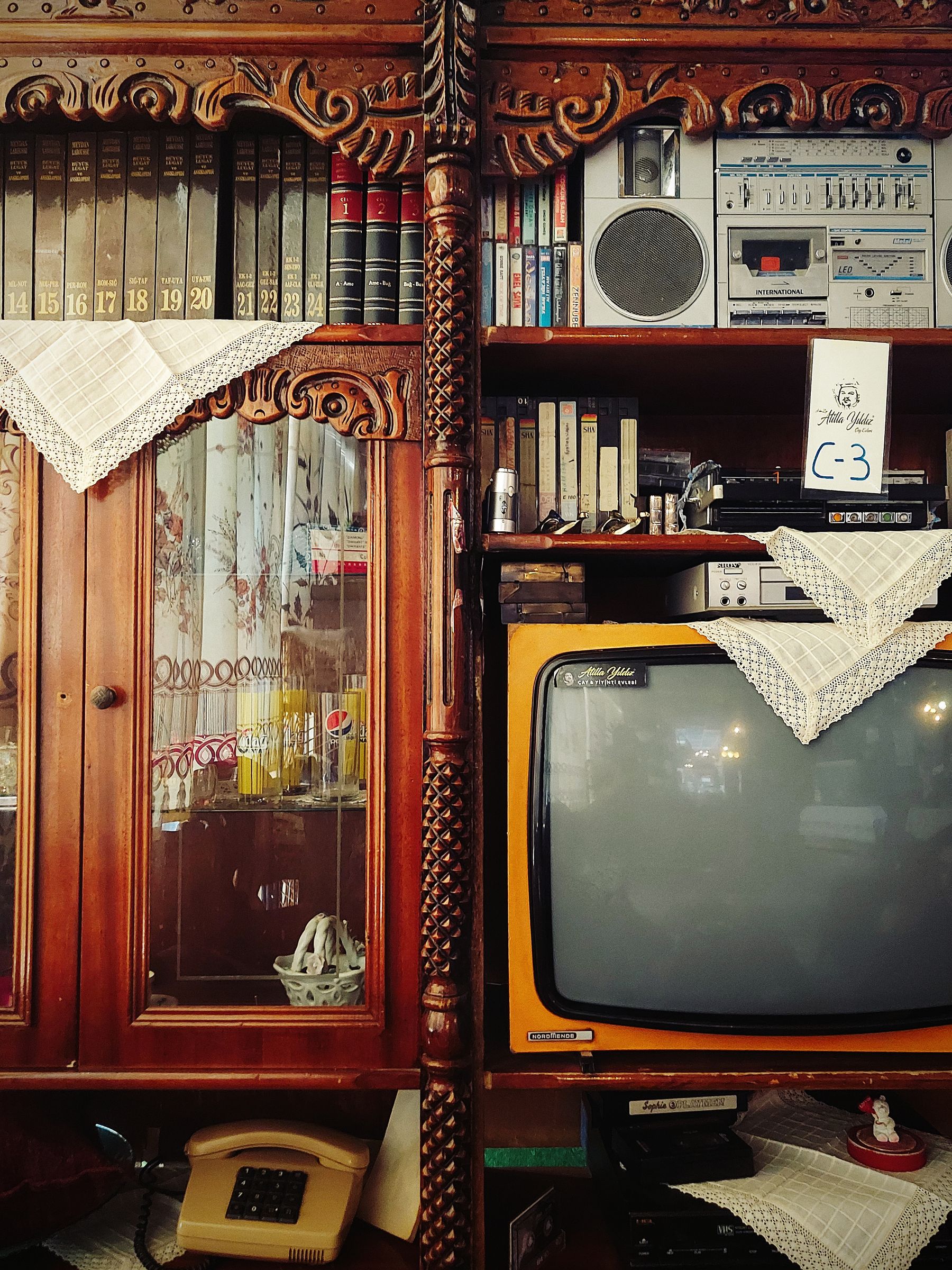 Retro living room with an old television, radio, books and layered period furnishings