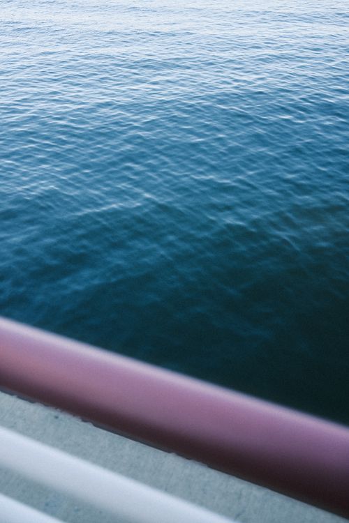 Free Serene blue ocean with abstract colorful railings, perfect for backgrounds. Stock Photo