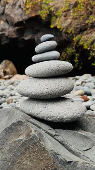 Serene stone cairn balancing in natural outdoor environment.