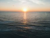 A serene ocean sunset with gentle waves and a colorful sky, perfect for tranquility and relaxation.