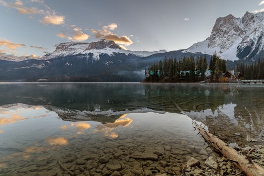 Tranquil scene of Emerald Lake with mountain reflections in Yoho National Park at sunset.