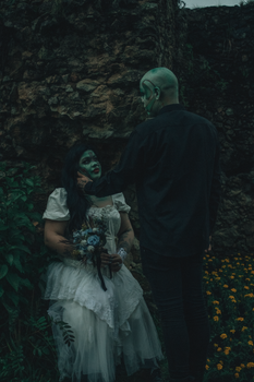 Dark fantasy scene with a mysterious couple in an outdoor setting, creating a dramatic mood.