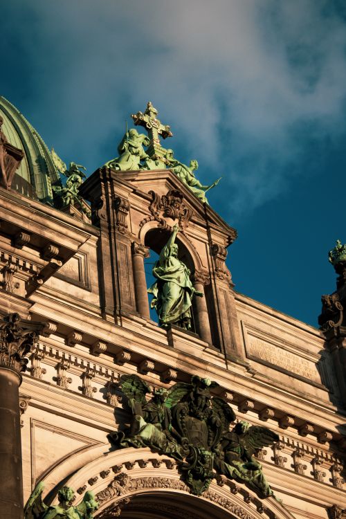 Free Close-up of Berlin Cathedral's intricate stone and sculpture details illuminated by sunset light. Stock Photo
