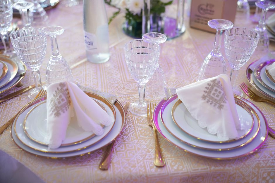Beautifully arranged formal table setting with crystal glassware and ornate napkins, ideal for weddings or special occasions.