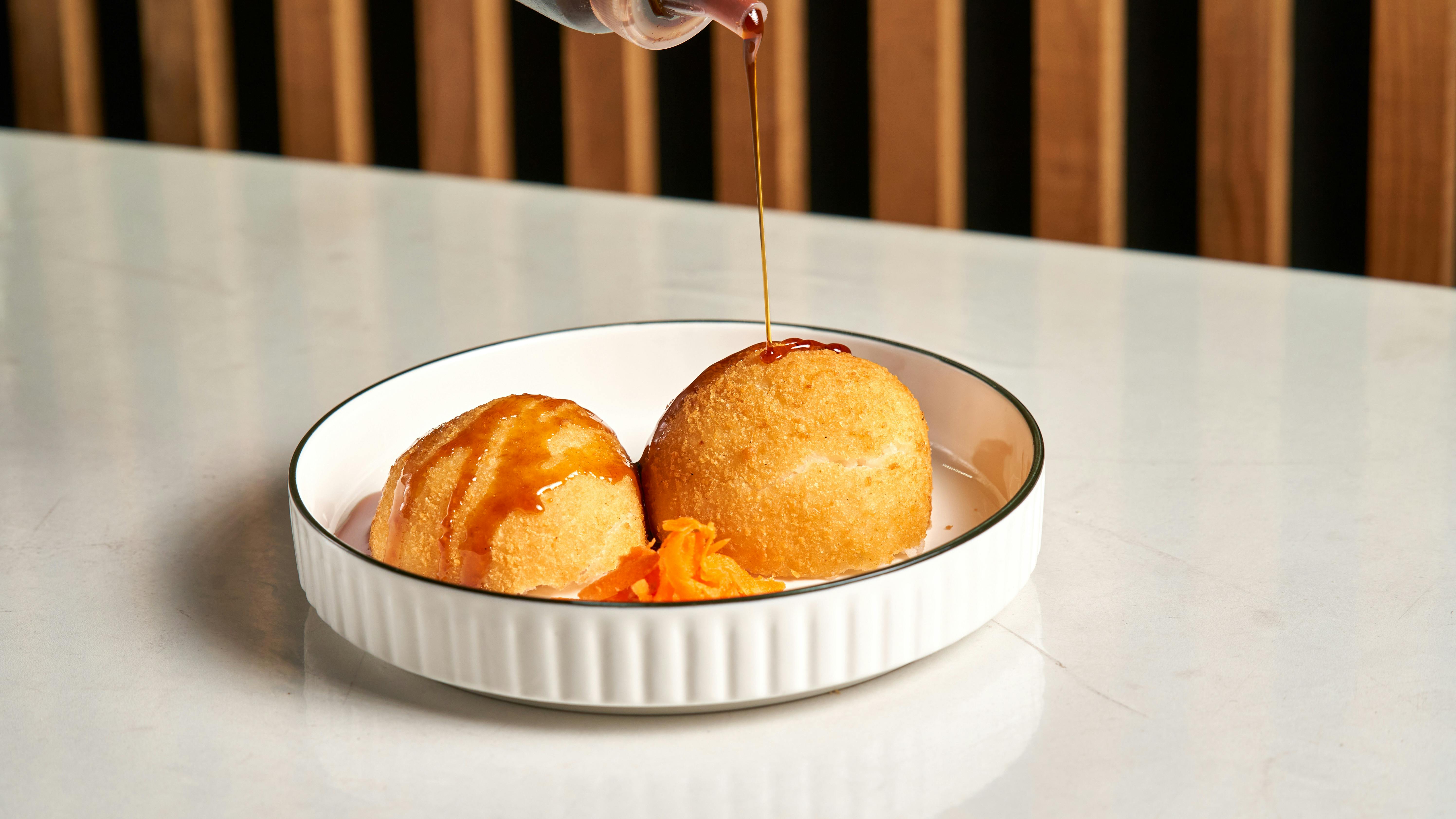 Gulab Jamun Dessert With Syrup And Garnished With Slivered Almonds Or Pistachios