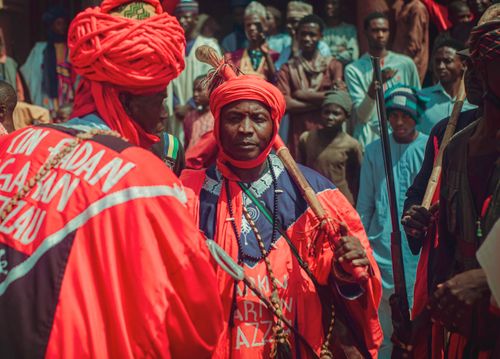 Free Vibrant depiction of a traditional Nigerian festival with people in colorful attire, showcasing cultural heritage. Stock Photo