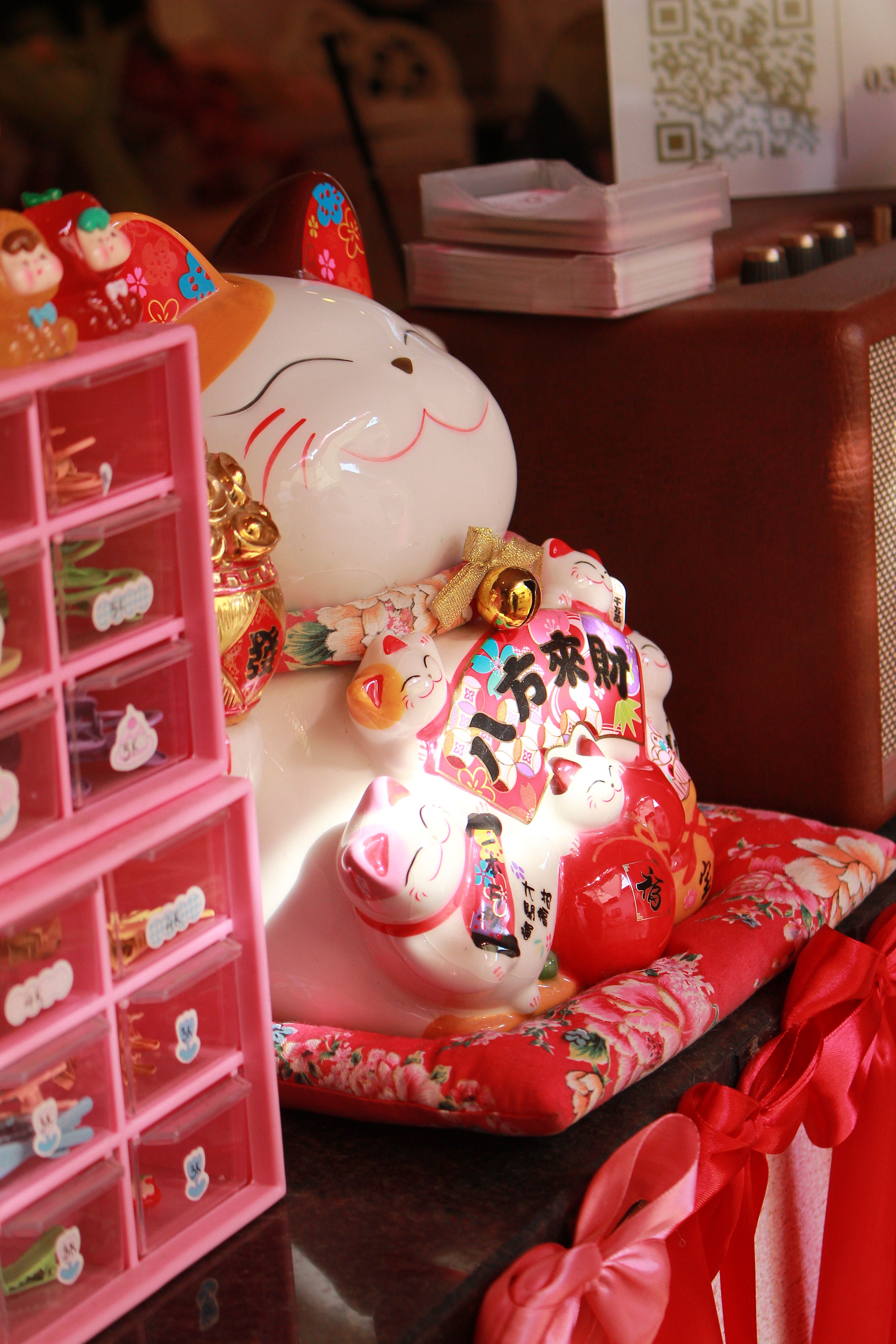 Colorful Maneki Neko Figurine on Display · Free Stock Photo