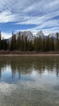 Majestic view of the Canadian Rockies reflected in a clear lake.