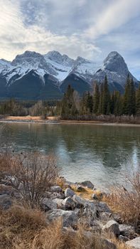 Idyllic landscape of snow-capped mountains and river in Canadian Rockies.