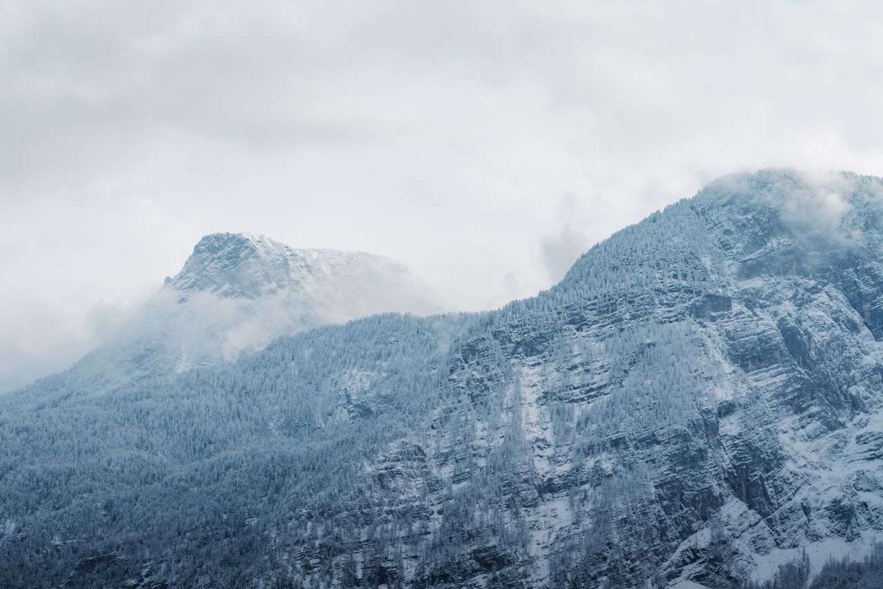 a captivating view of snow covered mountains with dramatic skies in wi