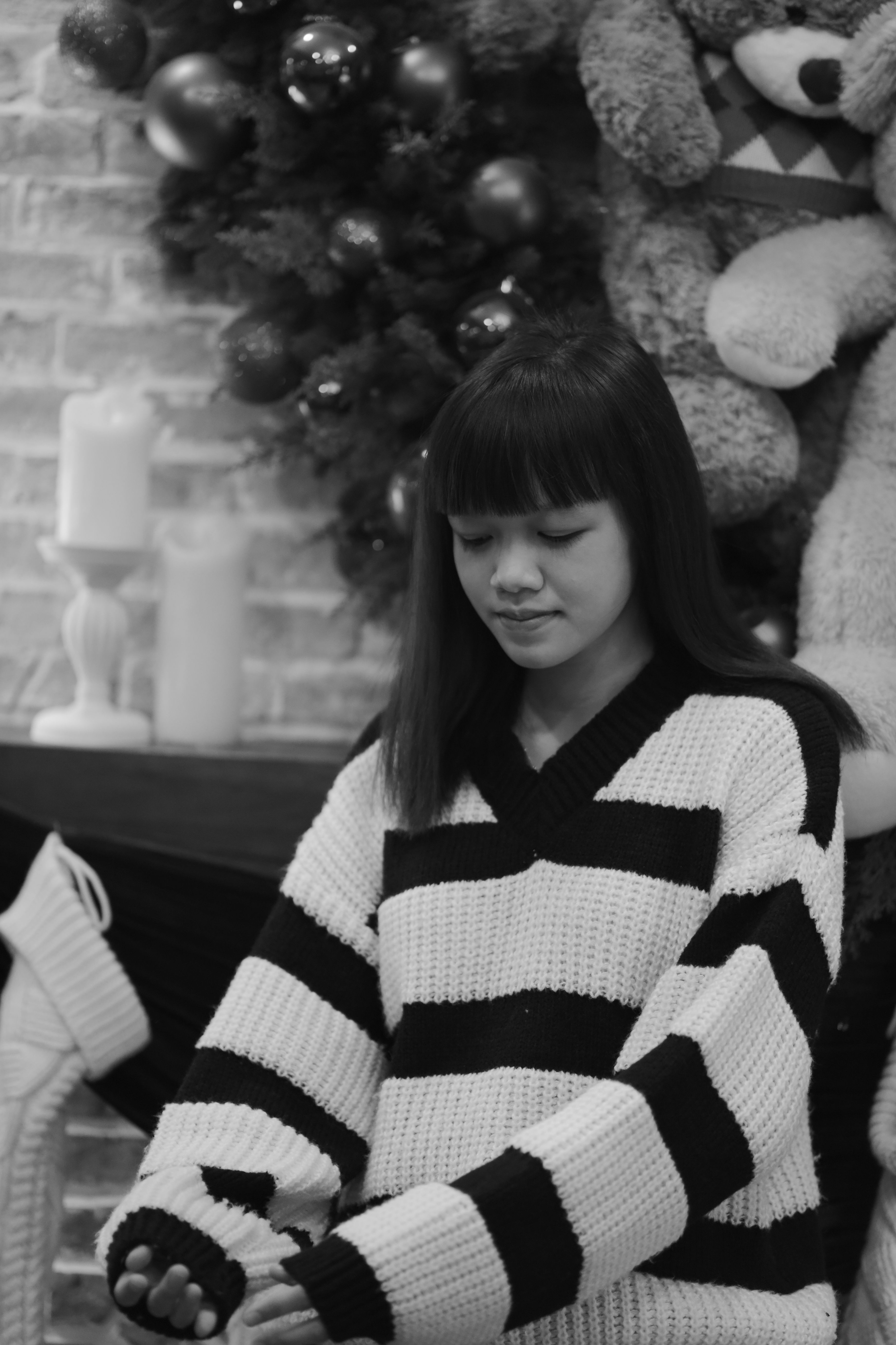 Young woman in a striped sweater enjoying a calm winter day indoors.