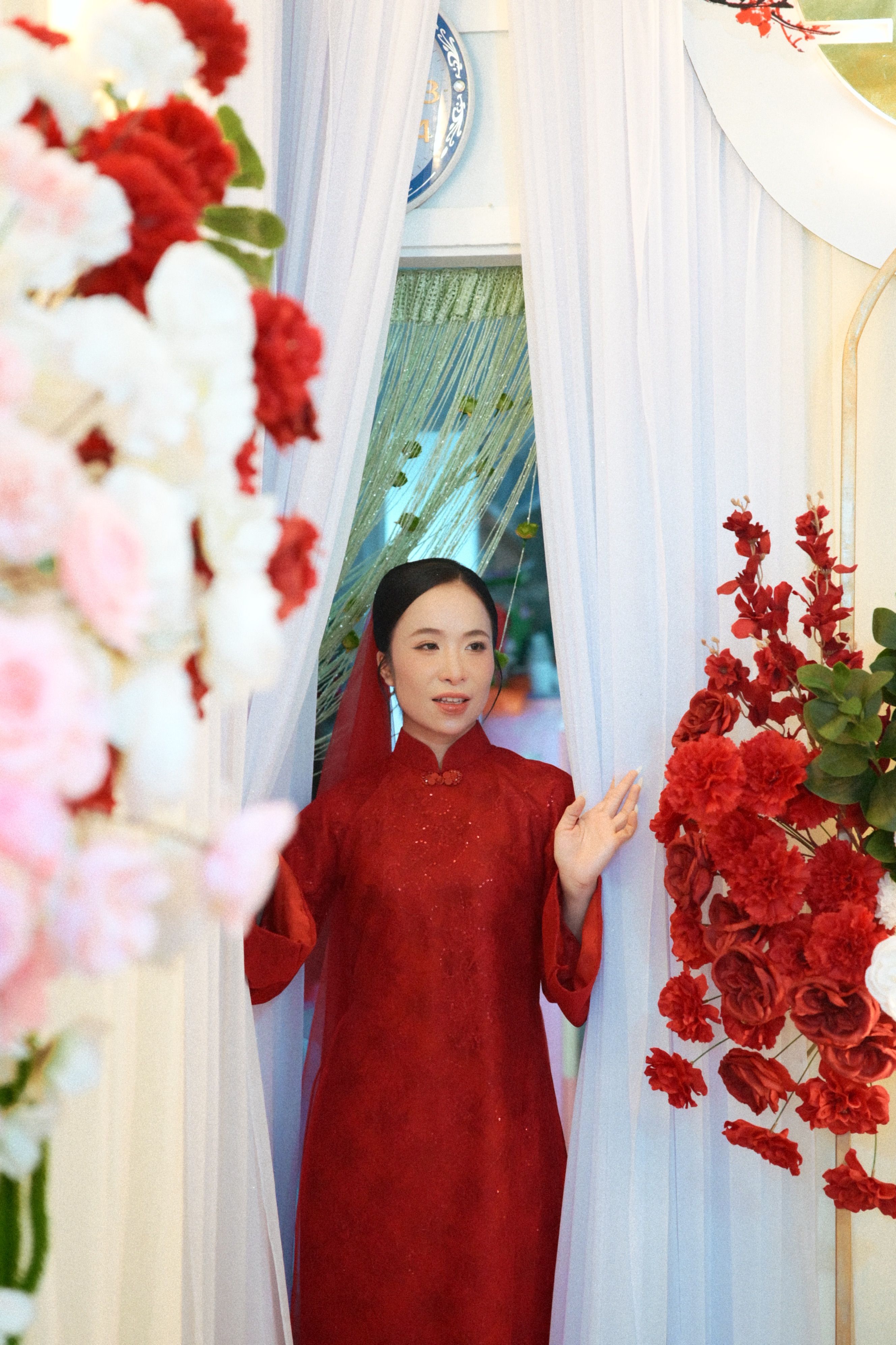 Elegant Woman in Traditional Red Dress at Floral Entrance · Free Stock ...