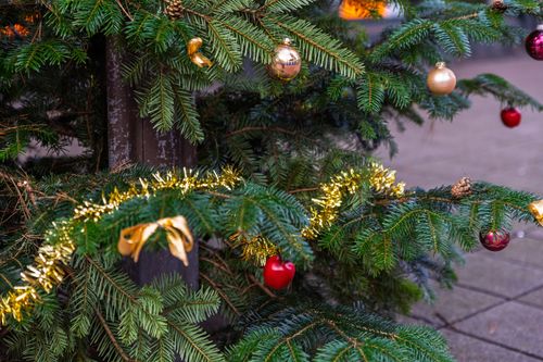 Free Close-up of a decorated Christmas tree with baubles and tinsel, embracing the festive spirit. Stock Photo