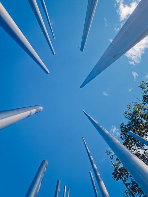 Free Artistic upward view of metal poles against a bright blue sky in Bucaramanga, Colombia. Stock Photo