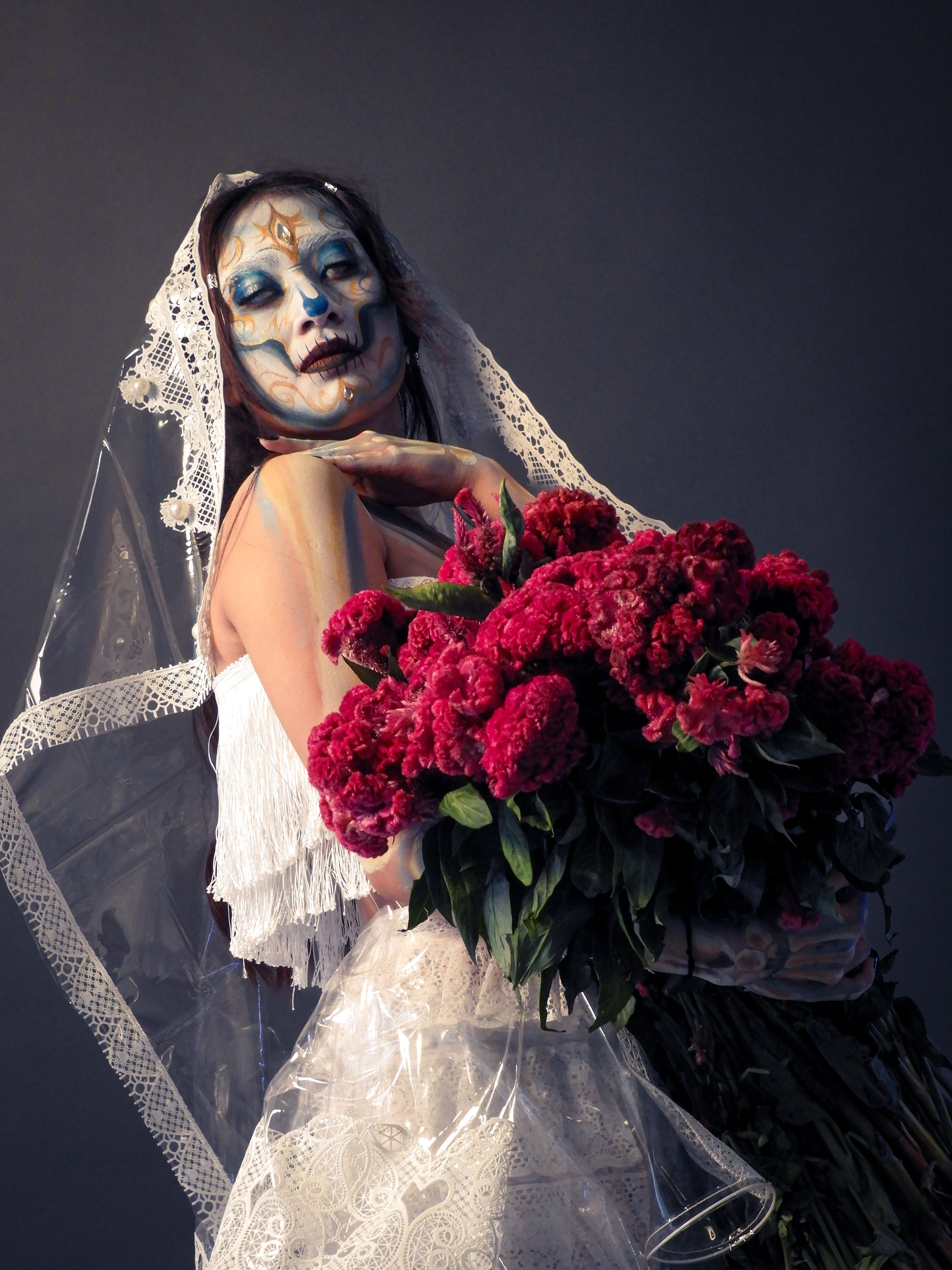 Day of the Dead Bride with Vibrant Flower Bouquet · Free Stock Photo