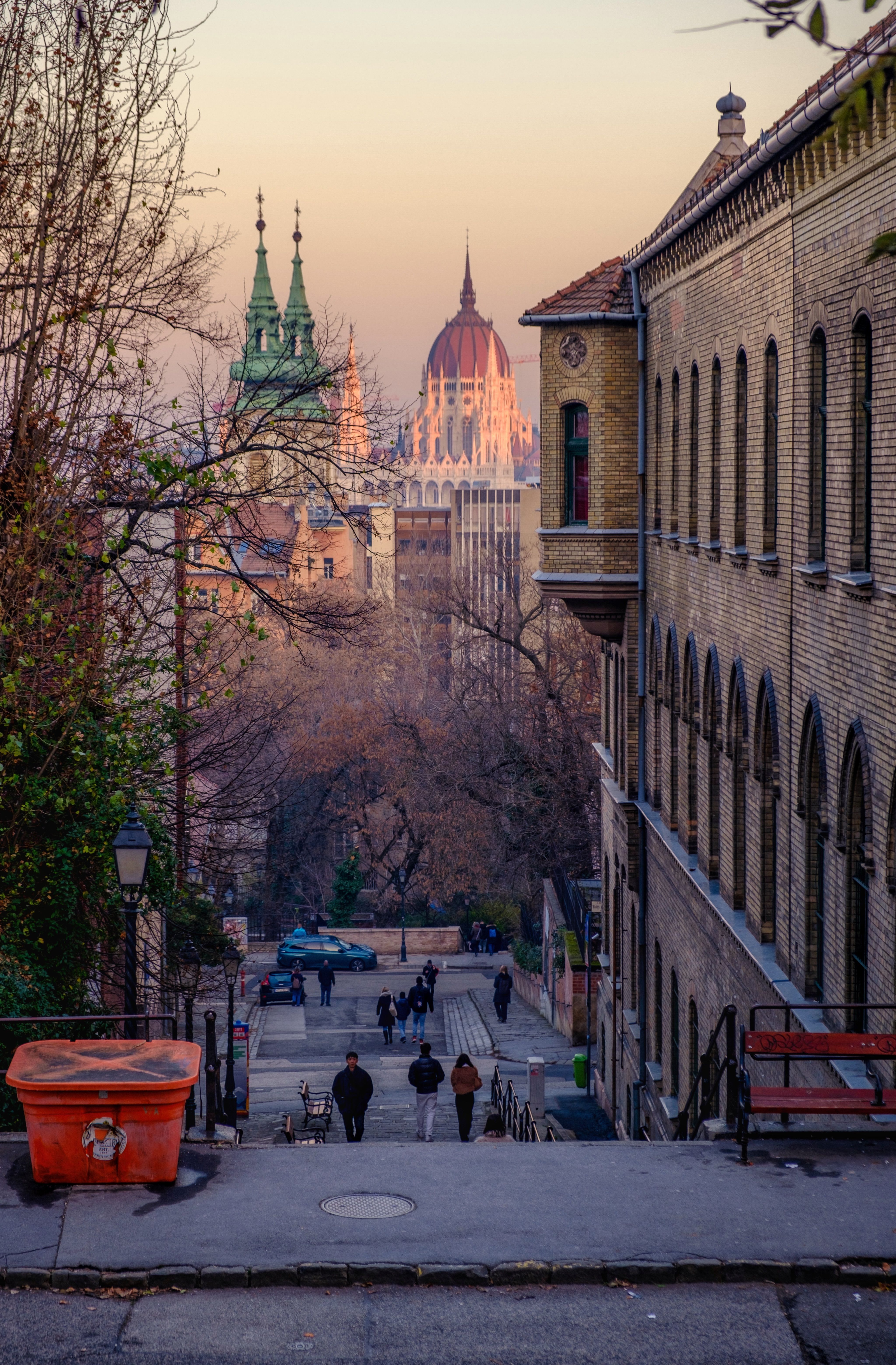 Picturesque view of Budapest featuring historic architecture and city streets at sunset.