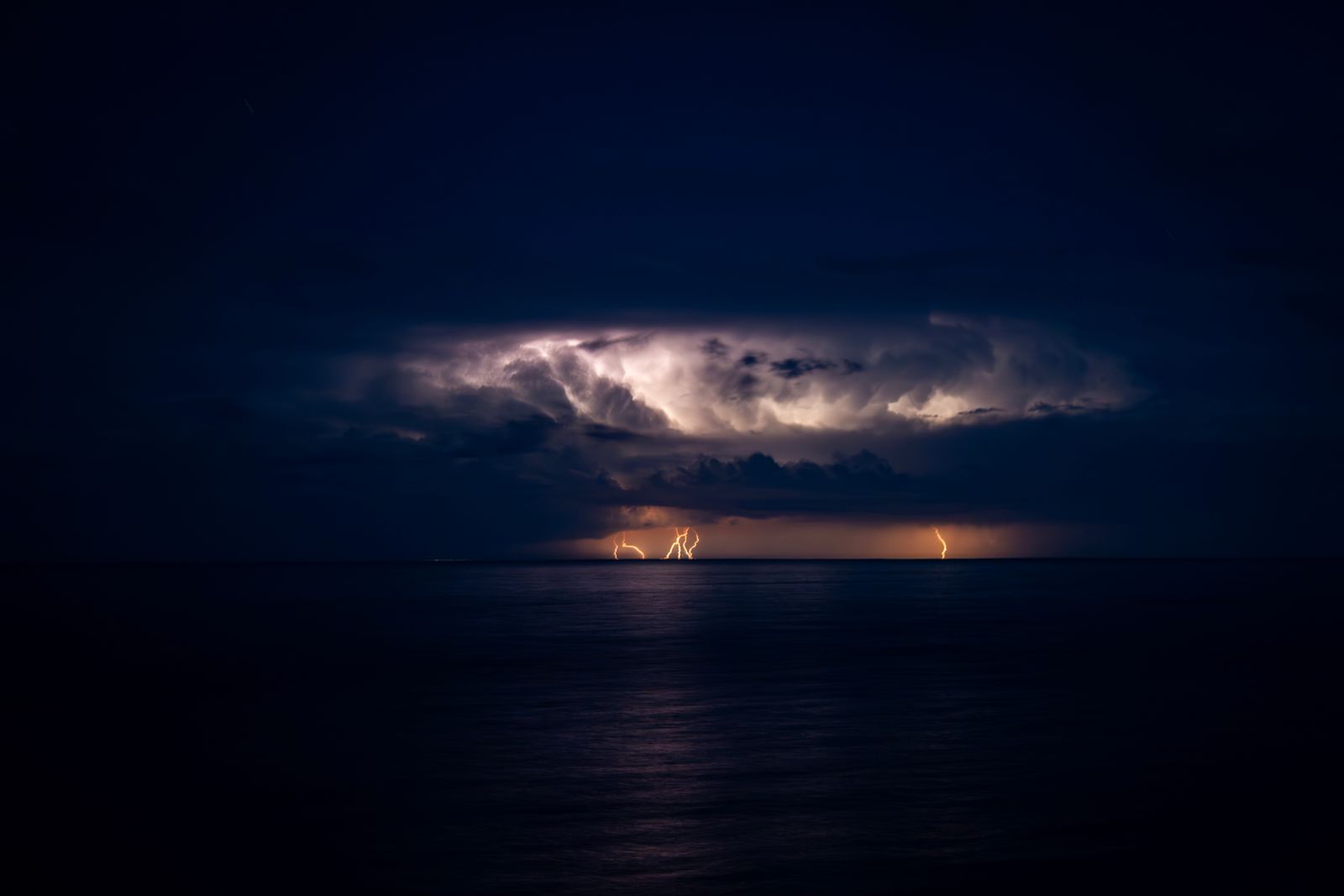 Dramatic Lightning Strike Over Tranquil Sea · Free Stock Photo