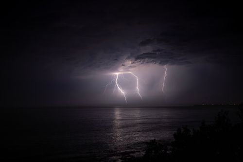 Free Striking night scene of a lightning storm over the ocean at Culburra Beach. Stock Photo