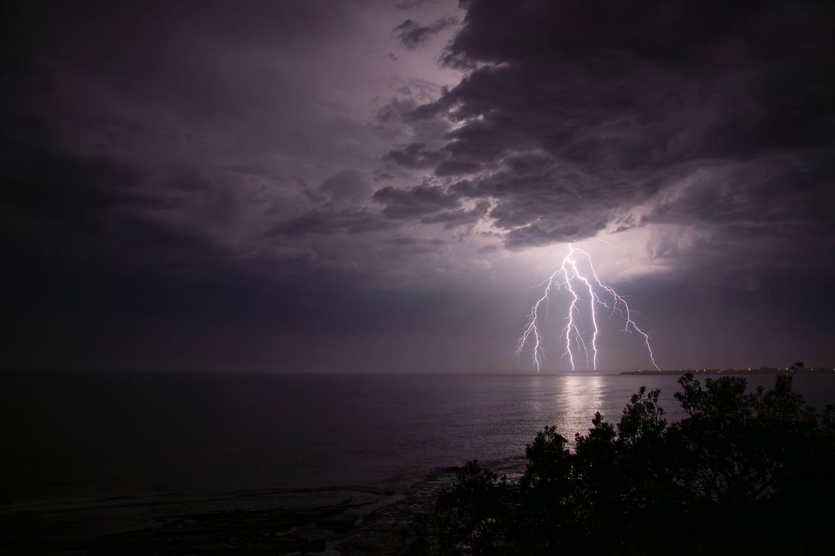 Dramatic Lightning Strike Over Tranquil Sea · Free Stock Photo