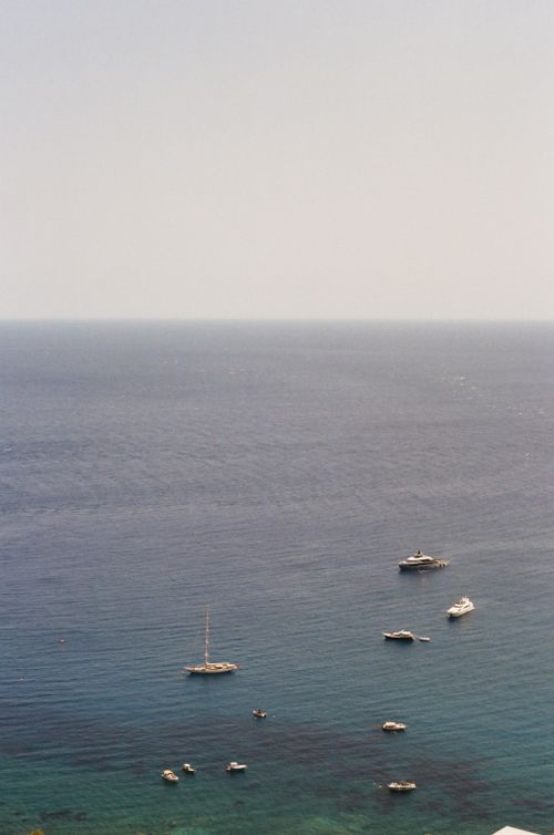 Free A serene scene of sailboats and yachts in clear blue waters near Taormina, Sicily. Stock Photo