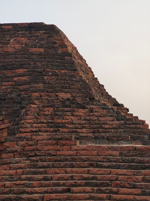 Free Close-up of an ancient brick pyramid structure with warm toned bricks under a sunset sky. Stock Photo