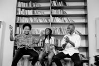 三个人在图书馆里被书架包围，享受着轻松的时刻