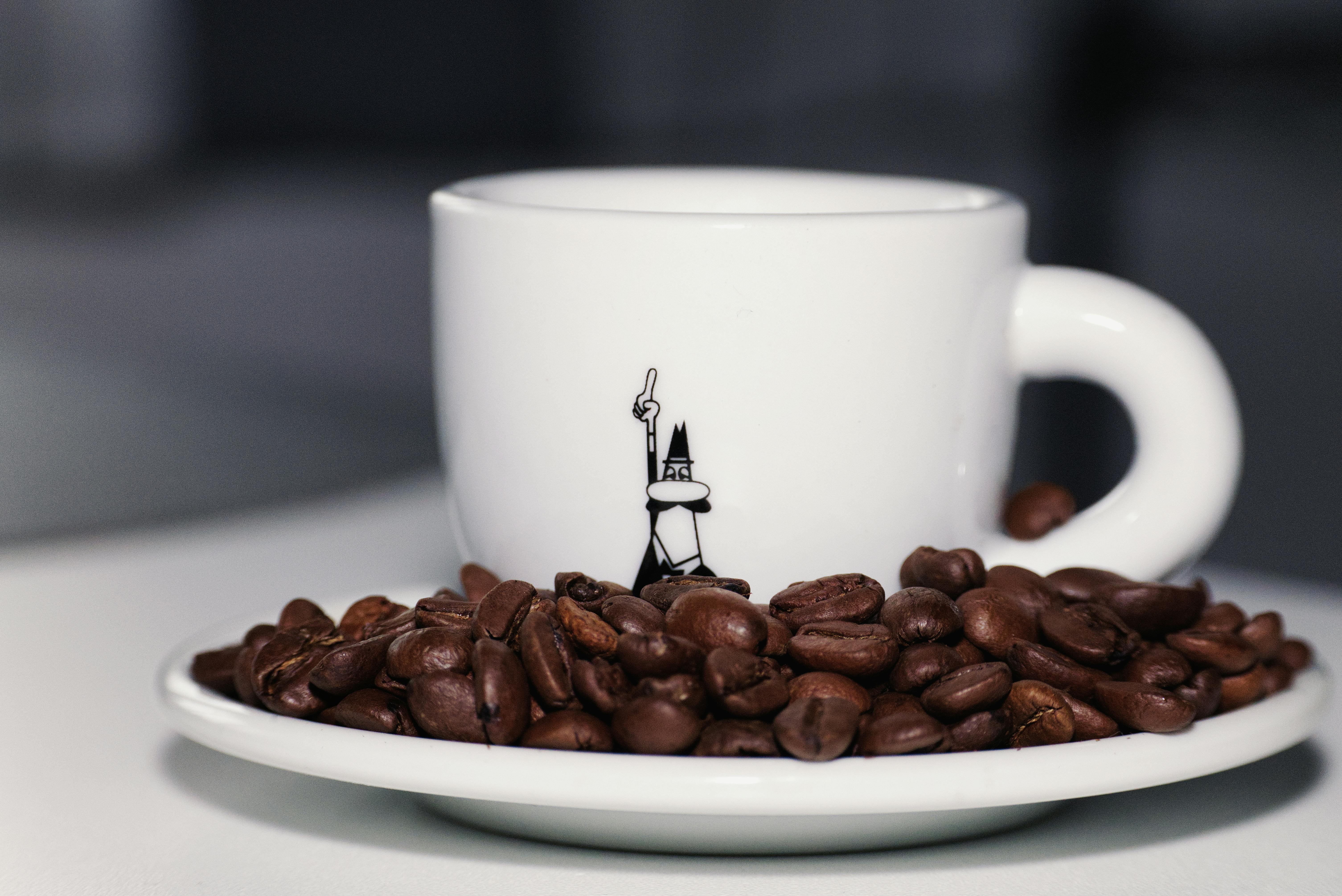 Elegant white coffee cup with beans, focusing on unique design and rich texture.