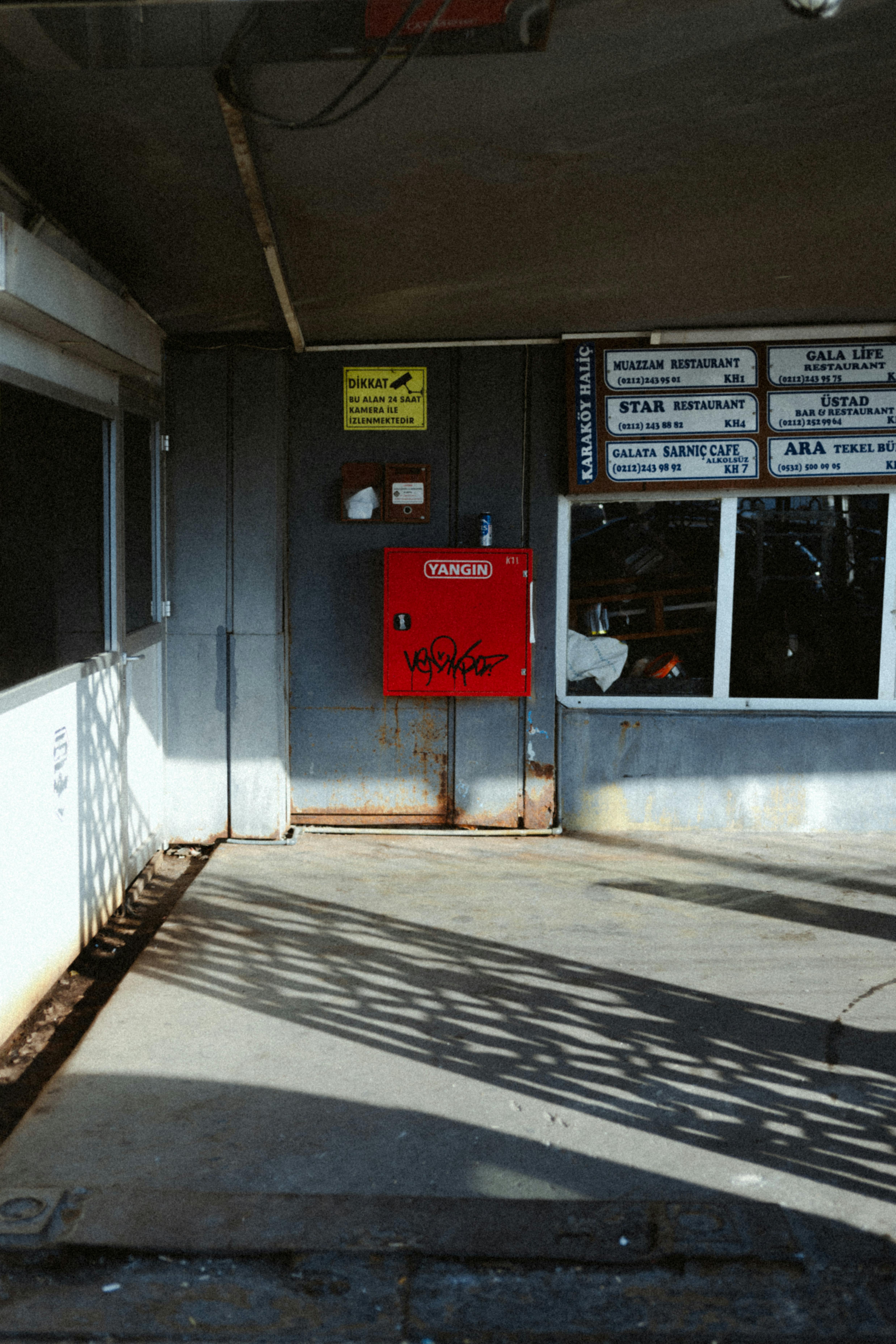 Gratis Scena di strada a Istanbul con un focolare rosso e motivi di ombre che accentuano il contrasto urbano. Foto a disposizione