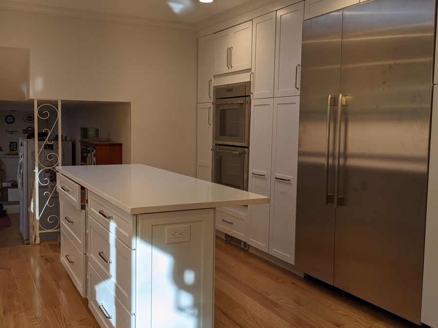 Open-plan renovated interior with island and skylight