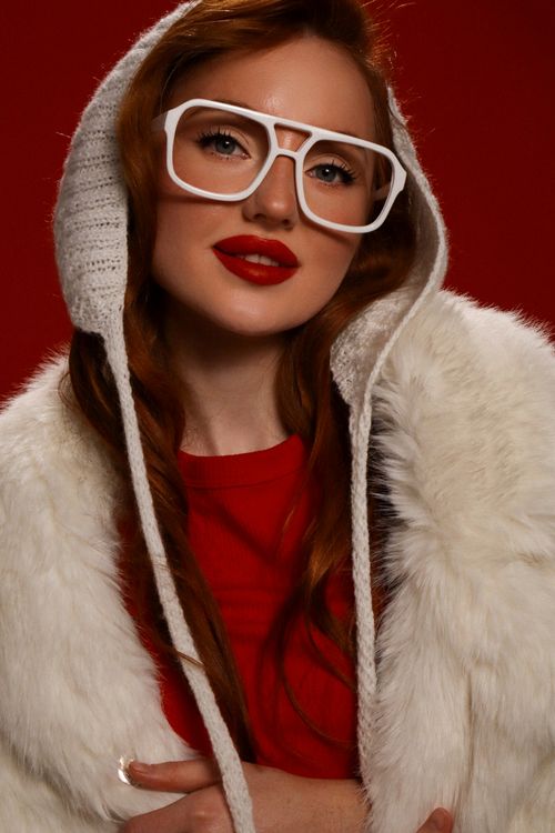 Free Chic woman in fur coat and oversized glasses, exuding modern winter fashion vibes. Stock Photo